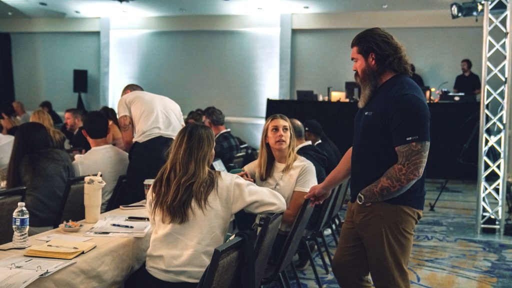 The Loud Rumor team, along with their experienced mentors, ensure personalized attention for every attendee. Pictured here is Matt Kafora offering tailored advice to Emily Rothrock, owner of Barre3-Bluebell, and her team lead, Jess.