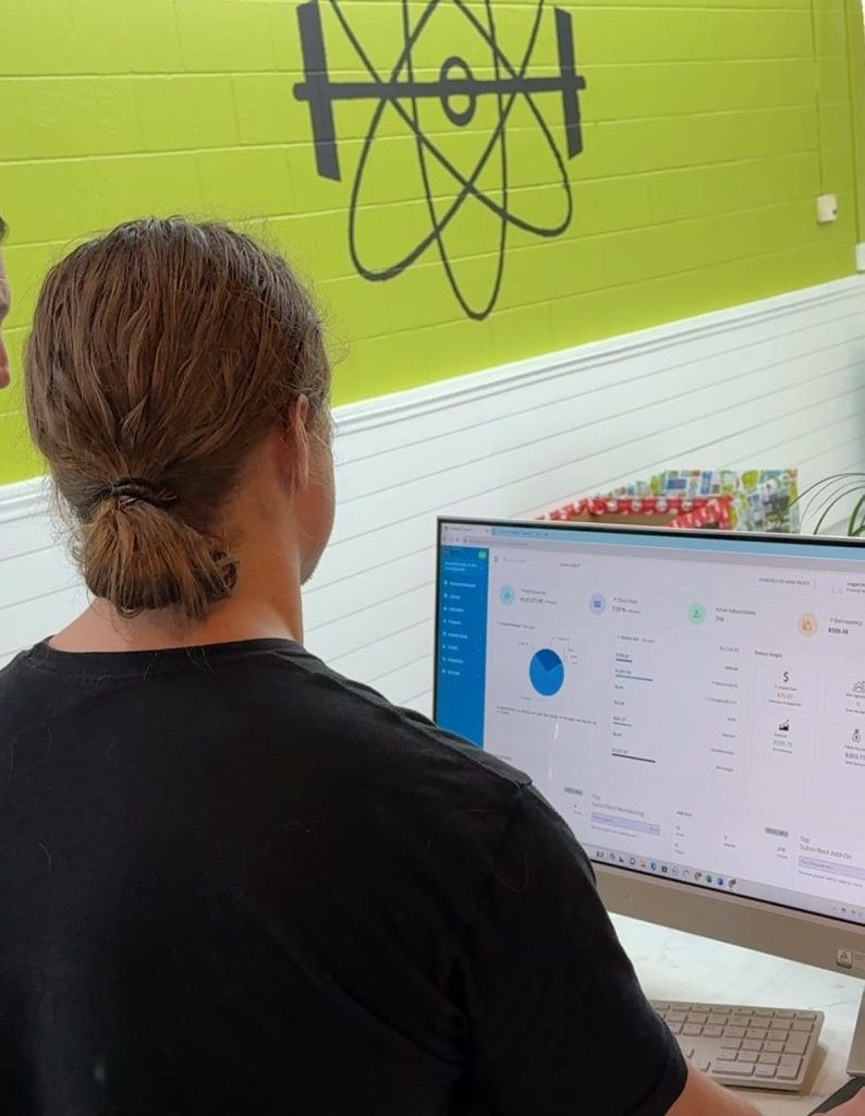 EnerGym staff reviewing the analytics and insights in BUZOPS Gym management software business dashboard.