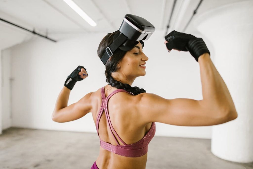 Happy woman feeling stronger and happier after working out with her VR headsets and VR equipment.