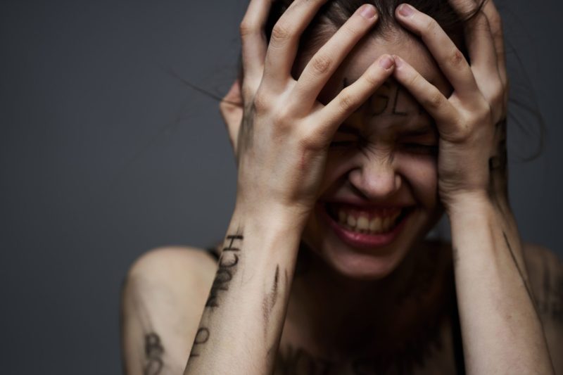 upset-woman-with-offensive-writing-on-her-body-on-2025-03-11-16-44-13-utc